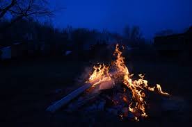 Tourists enjoying a warm bonfire at night in the Sundarbans mangrove forest