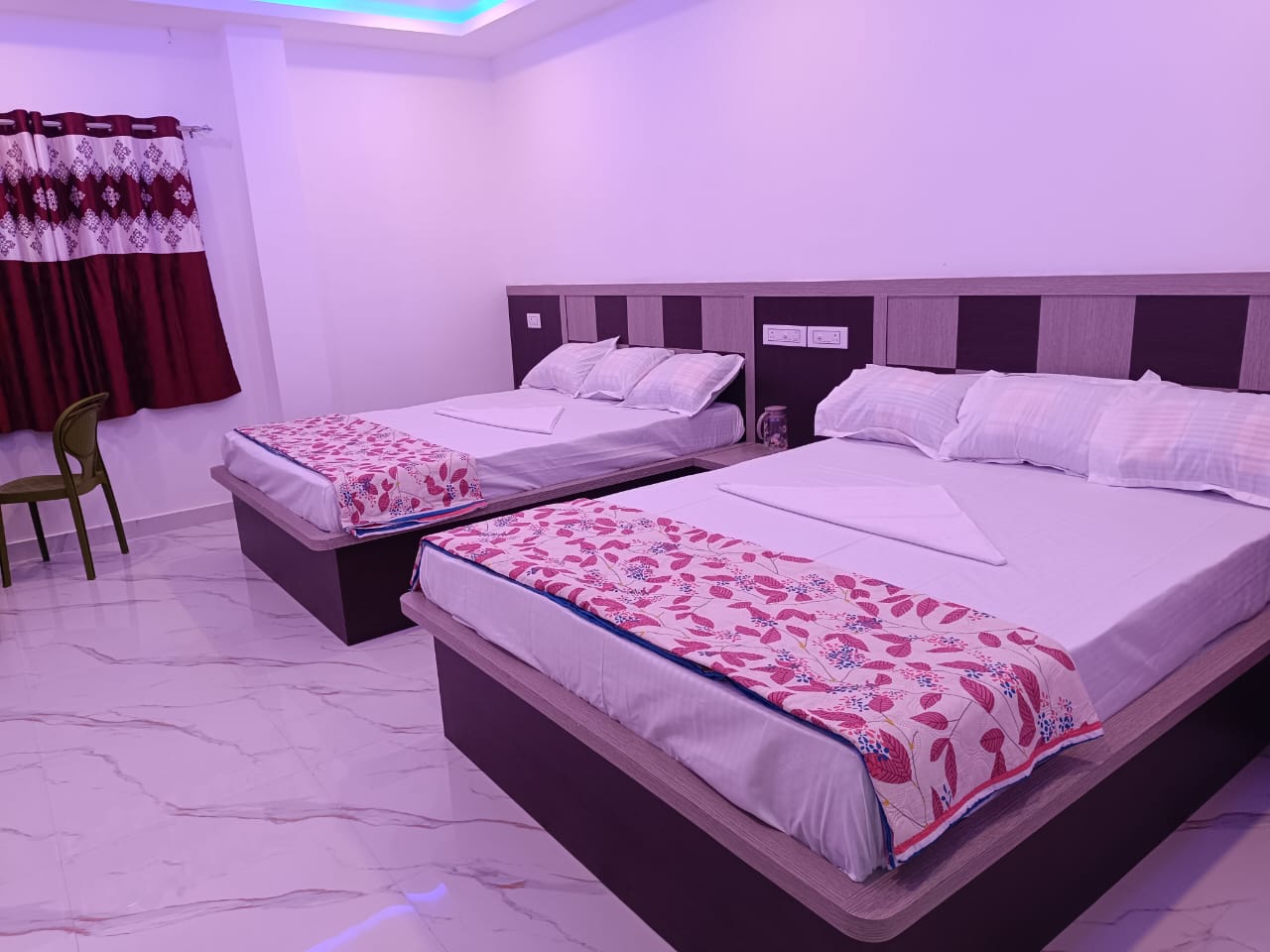 Spacious deluxe bedroom with modern decor at Sundarbans resort