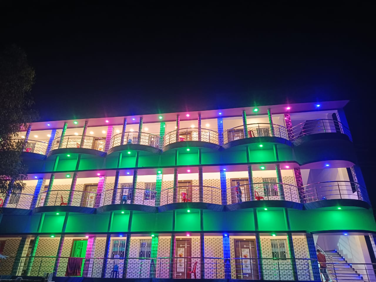 Night view of resort in Sundarbans with glowing lights and reflection on water